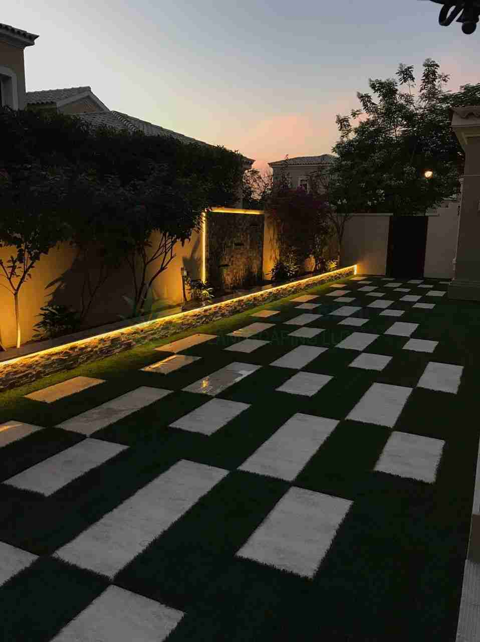 garden lights in backyard with paved lawn