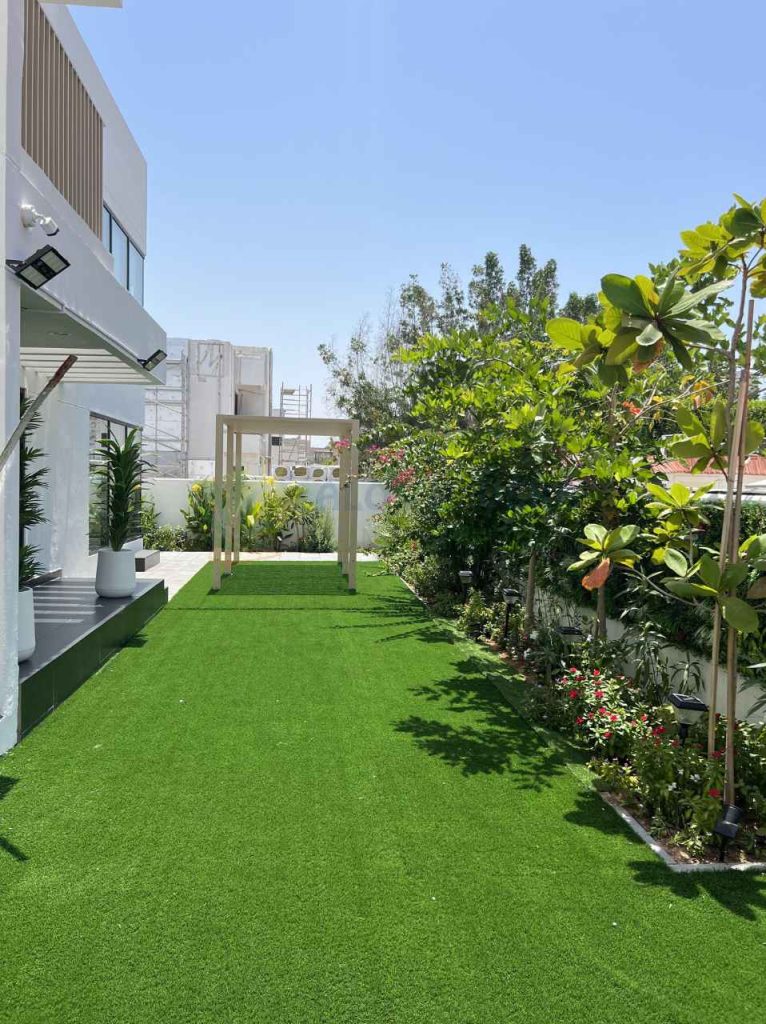 beautiful lawn area with colorful plants and grass