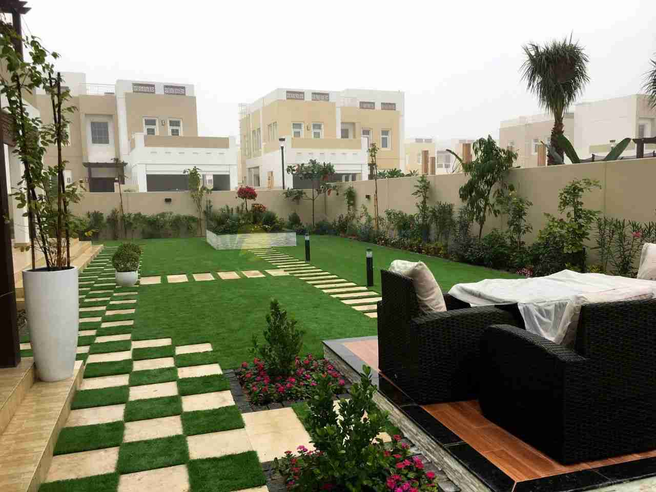 front lawn with paved walkways and a sitting area