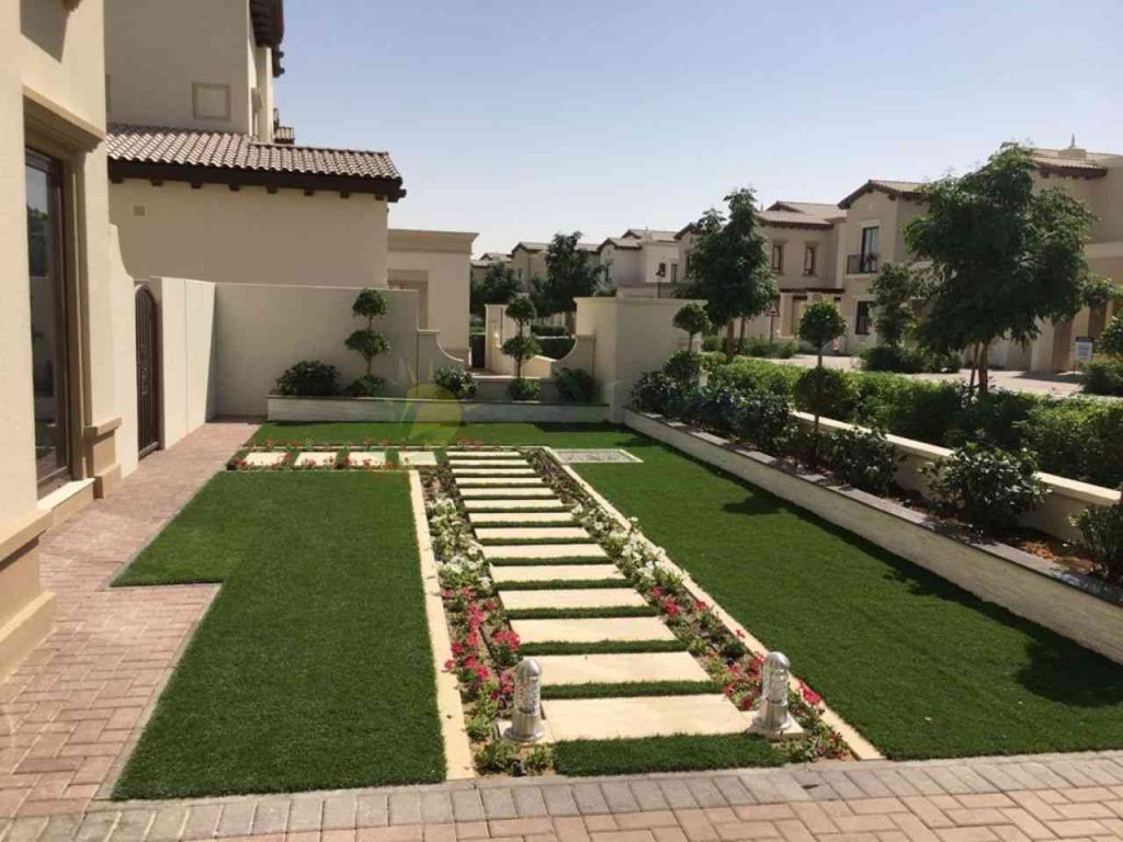 properly paved and decorated walkway in front lawn