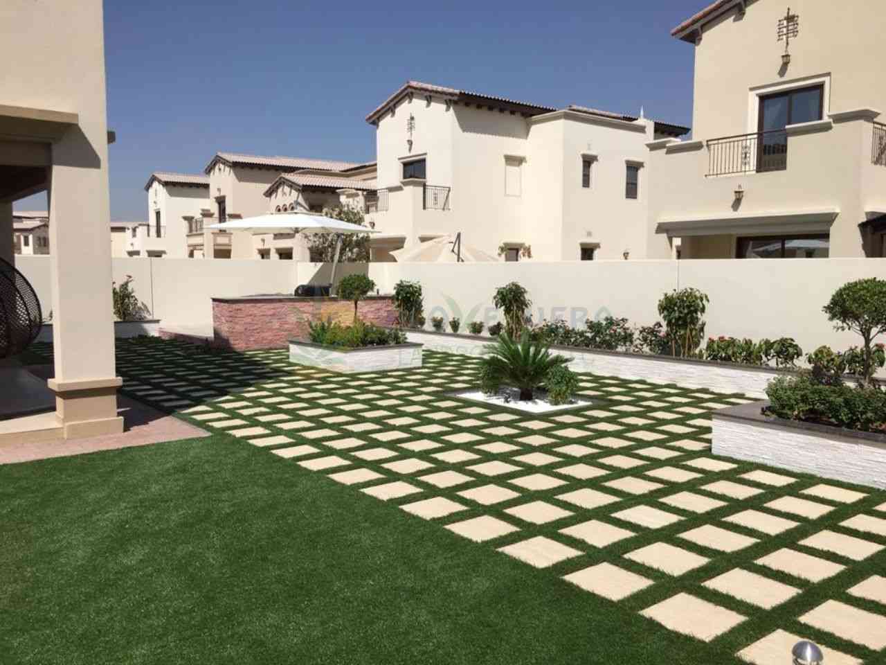 A wide if backyard with landscaping work of planting and making soil beds and paving