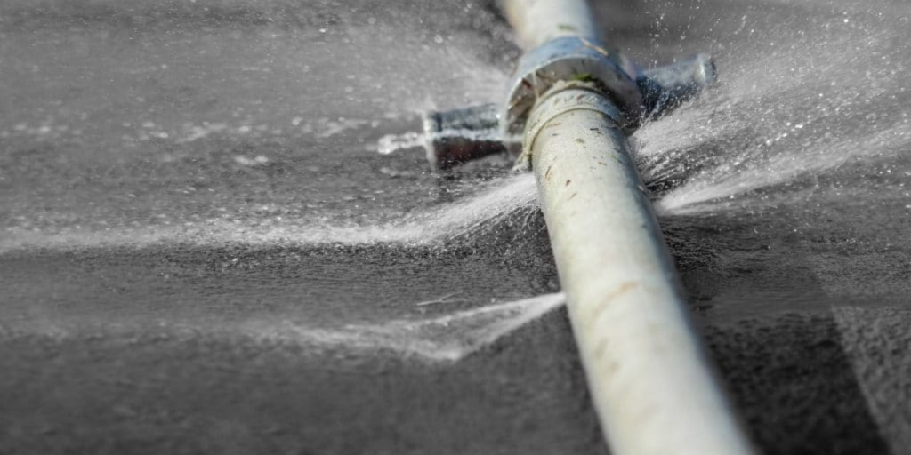 A leaked pipe of water lying on the floor